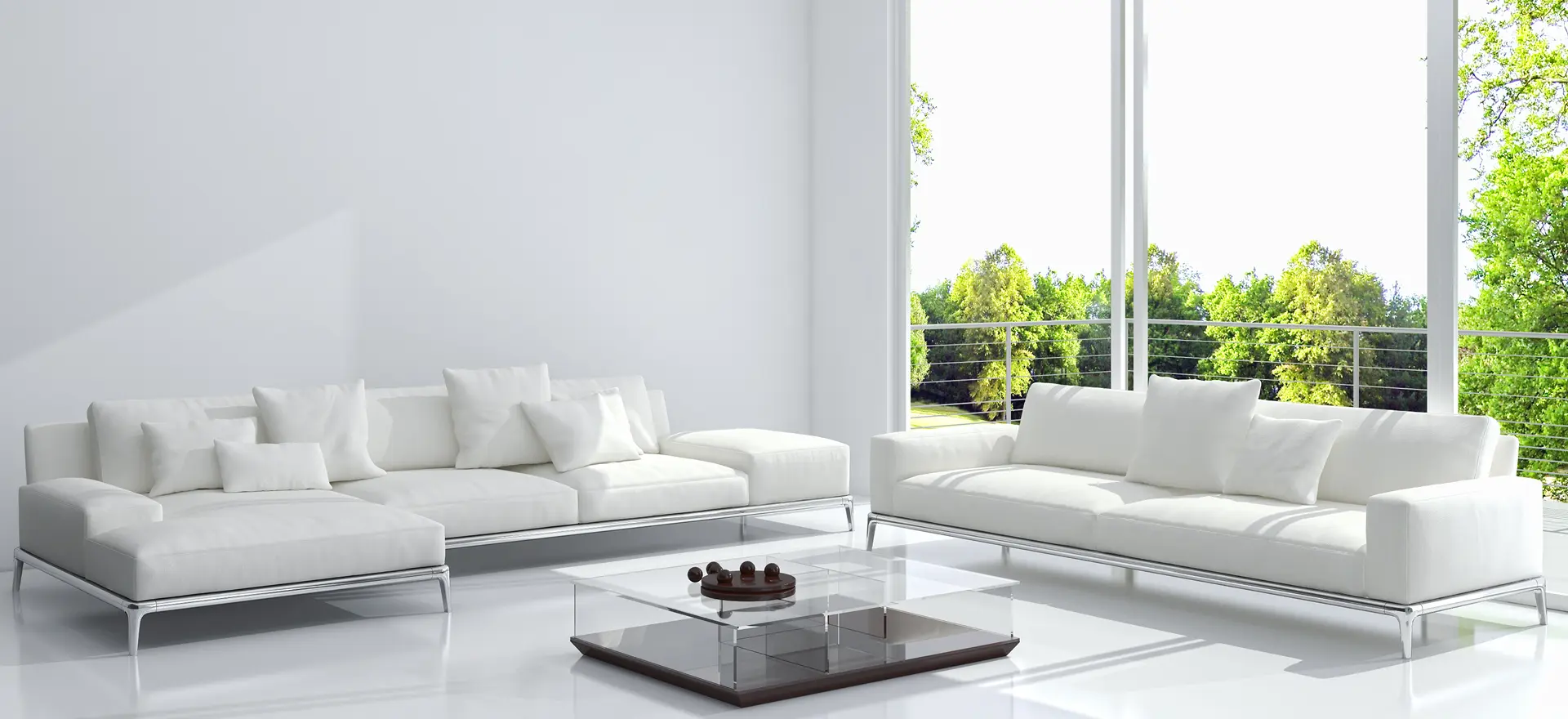 Bright living room with two white sectional sofas around a glass coffee table